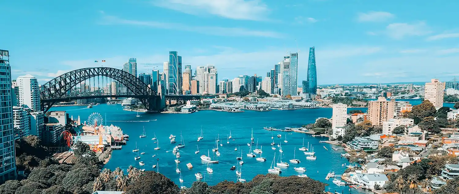 Cityscape with skyscrapers and harbour with boats and bridge