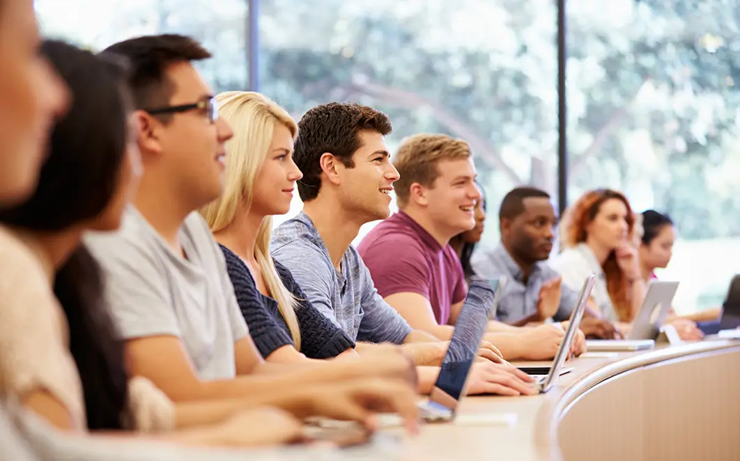 Students sitting in a row in a lecture theatre